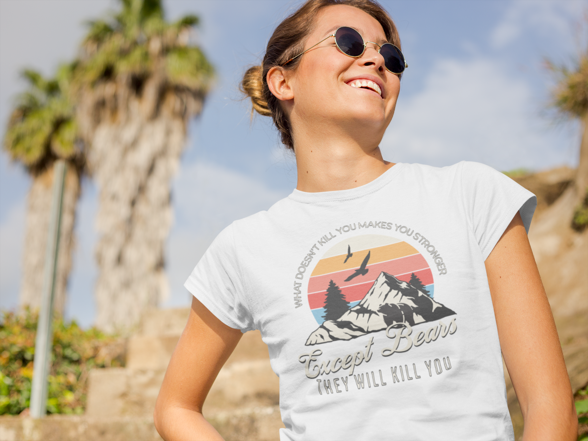 White women’s graphic tee with “What Doesn’t Kill You Makes You Stronger (Except Bears)” slogan in bold print.