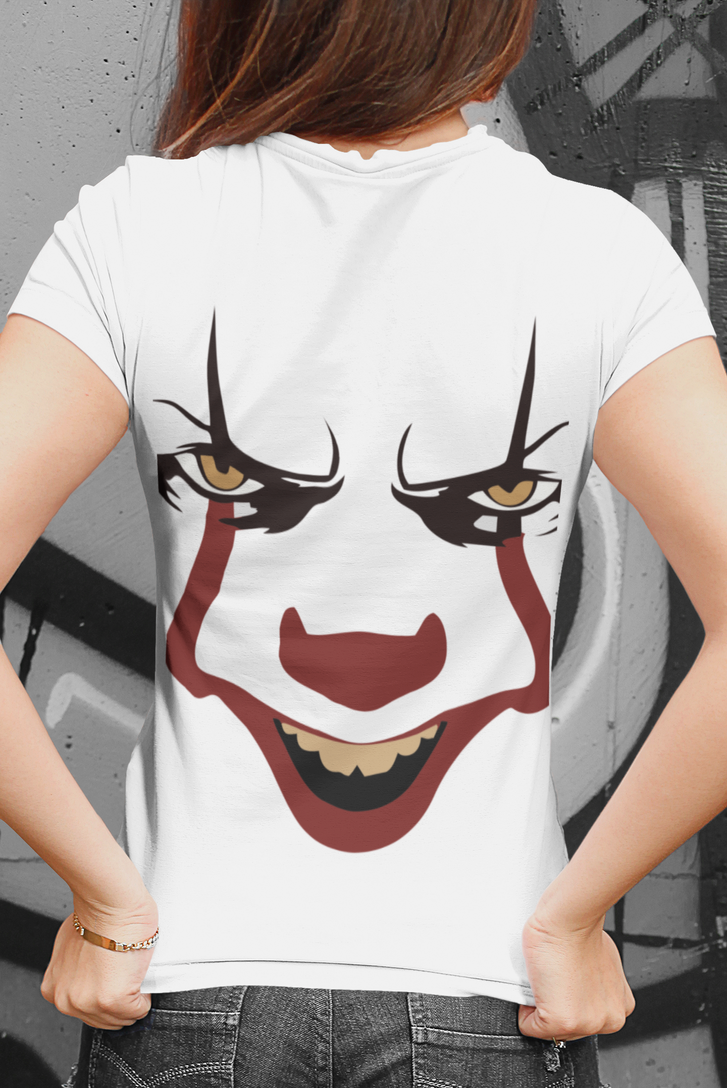 Person wearing a white t-shirt with a clown face design on the back.
