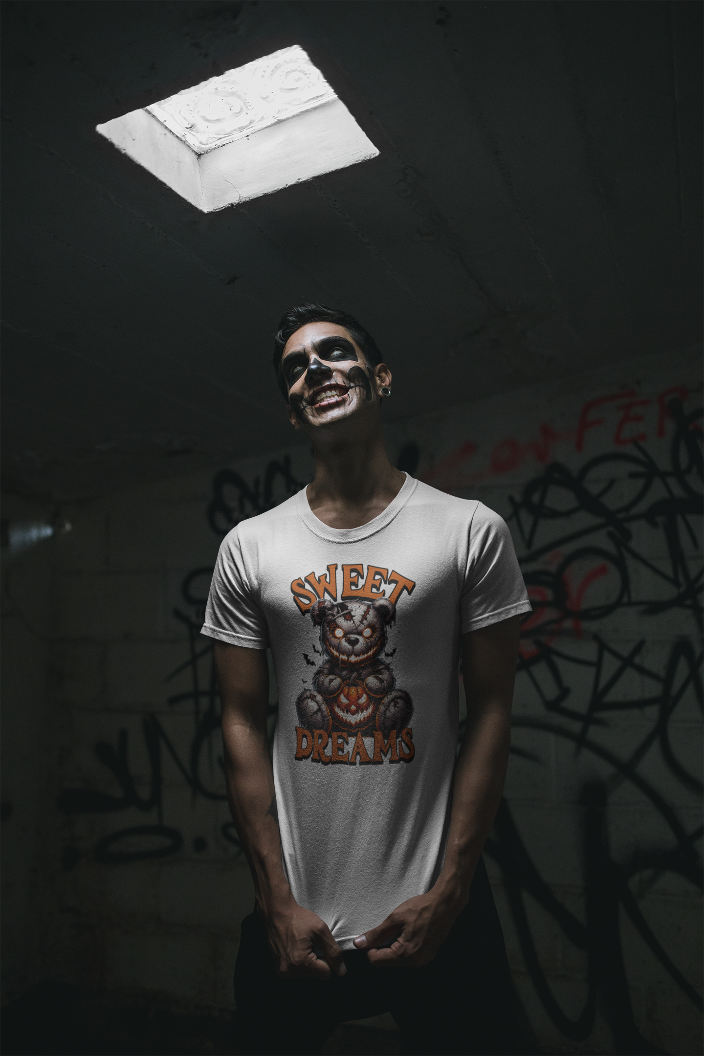 Person wearing a 'Sweet Dreams' t-shirt in a dark room with graffiti.