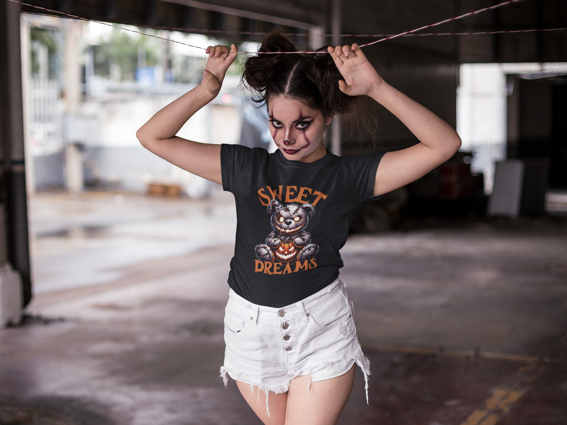 Woman wearing a black t-shirt with Sweet Dreams horror movie slogan and flattering tailored cut.
