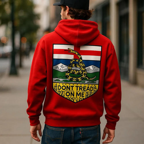 Person wearing a red hoodie with a 'Don't Tread on Me' design on the back, walking down a city street.